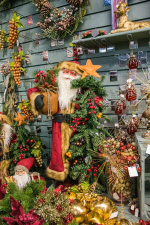 Father Christmas-Santa Claus. Christmas decorations on sale in a garden centre, near Lacock, Englandの写真素材