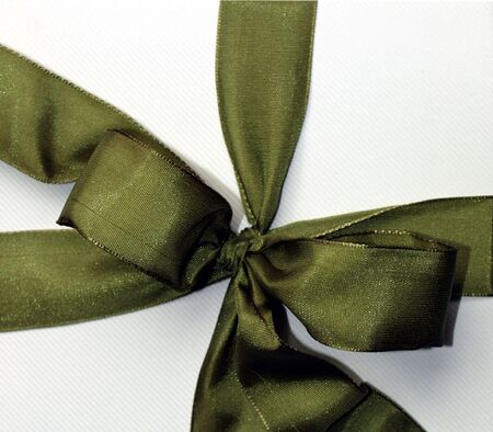 Green ribbon over cardboard box for presentの写真素材