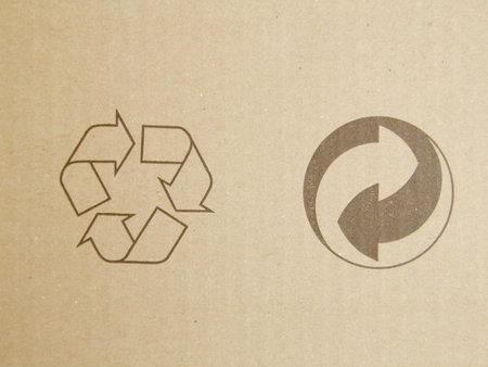 Brown corrugated cardboard sheet with recycling symbolの写真素材