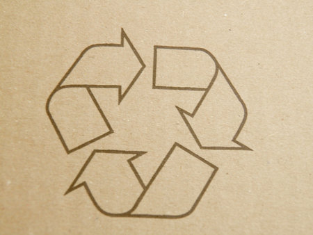 Brown corrugated cardboard sheet with recycling symbolの写真素材