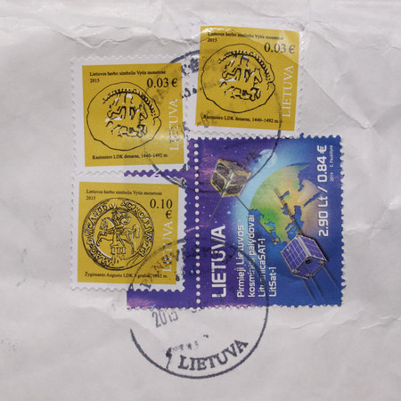 VILNIUS, LITHUANIA - CIRCA MAY 2015: Lithuanian mail stamps from Lithuania with postage meter over white envelopeのeditorial素材