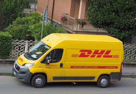 MILAN, ITALY - CIRCA AUGUST 2015: DHL van parked on a street. DHL is a world wide courier company...
