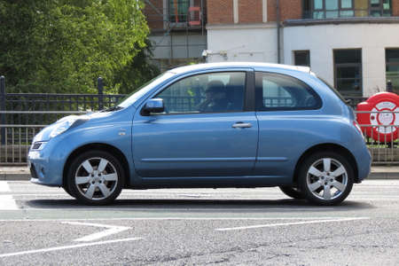 YORK, UK - CIRCA AUGUST 2015: light blue Nissan Micra car in a street of the city centre.のeditorial素材