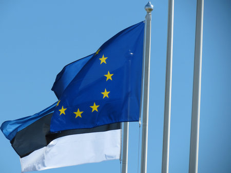 Flag of Europe and Flag of Estonia over a blue sky