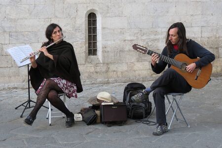 SIENA, ITALY - CIRCA APRIL 2016: due (traverso flute and guitar) performing on a square of the city centreのeditorial素材