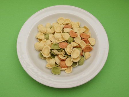 Orecchiette pasta from Apulia, Italy, in three colours (natural, spinach green, beetroot red)の写真素材