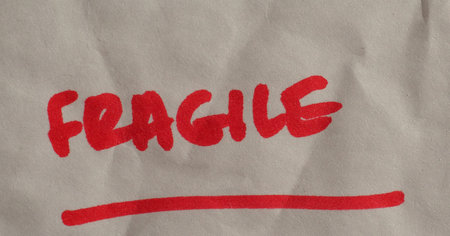 Fragile handwritten warning in red ink over white background