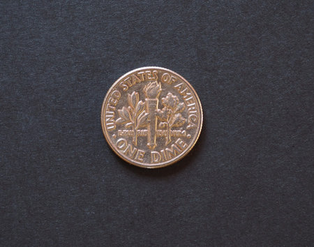 10 cents or 1 dime coin money (USD), currency of United States, over black paper background
