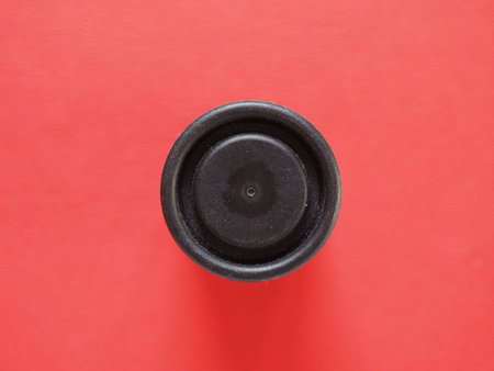 circular plastic box over a red backgroundの写真素材