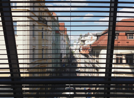 BRNO, CZECH REPUBLIC - CIRCA MAY 2016: a street of the city centre with shop signs seen from behind a sunshadeのeditorial素材