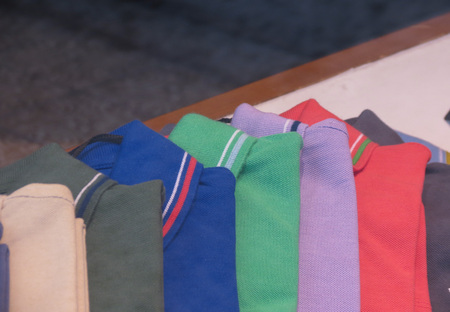 Detail of polo shirts on display for sale in a department storeの写真素材
