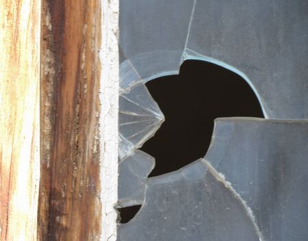 Smashed window glass useful as risk or danger conceptの写真素材