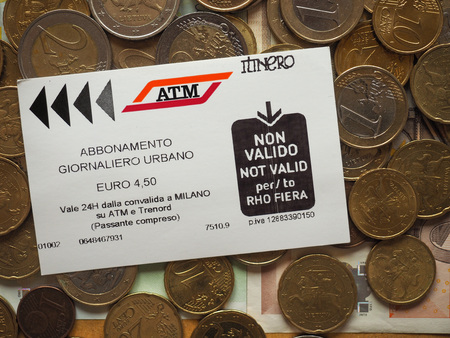 MILAN, ITALY - CIRCA JULY 2017: public transport daily pass over euro coins backgroundのeditorial素材