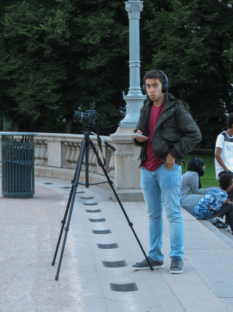 OSLO, NORWAY - CIRCA AUGUST 2017: unidentified photographer with tripod and headphones