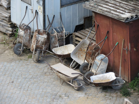 Old wheelbarrow hand propelled vehicles left at a construction site