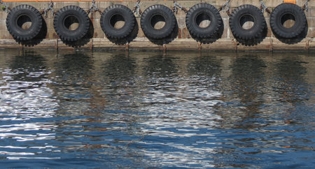 Old tire line on a stone wharf in Copenhagen, Denmark