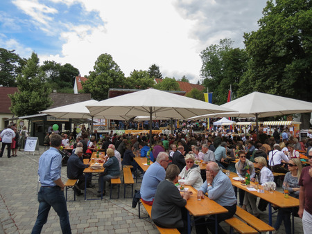 POYSDORF, AUSTRIA - CIRCA JUNE 2018: crowd seated eating at the apricot crop festivalのeditorial素材