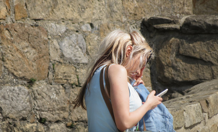 VIENNA, AUSTRIA - CIRCA APRIL 2016: unidentified fashion model checking her mobile phoneのeditorial素材