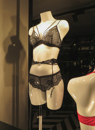 MADRID, SPAIN - CIRCA OCTOBER 2017: black lingerie set including triangle bra, suspender belt, French knickers, on display in a store front windowのeditorial素材