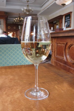 DRESDEN, GERMANY - CIRCA MARCH 2016: glass of white wine on a restaurant tableのeditorial素材