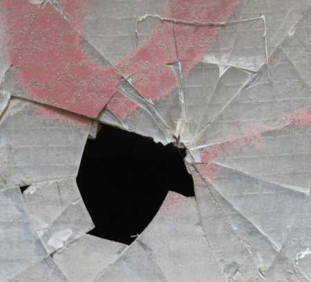 Smashed window glass useful as risk or danger concept