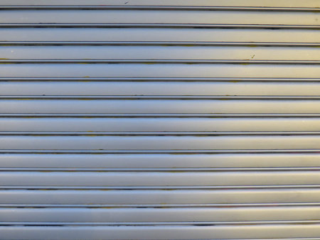 Gray metal roller shutter door surface useful as a background