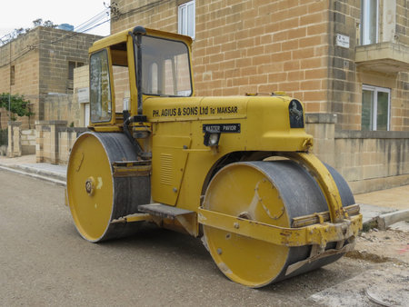 VALLETTA, MALTA - CIRCA MAY 2019: steel road roller parked in a street with road works