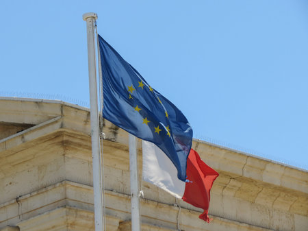 the Maltese national flag of Malta floating together with the EU flag