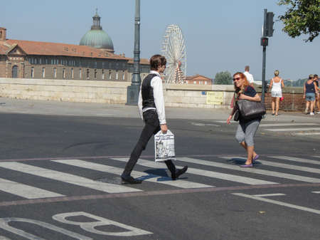 TOULOUSE, FRANCE - CIRCA AUGUST 2018: people crossing the street by the Pont Neuf (translated " New Bridge ")のeditorial素材