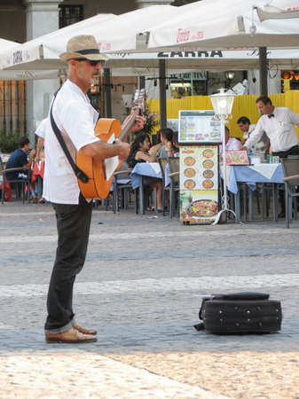MADRID, SPAIN - CIRCA JUNE 2015: street musician playing guitar on Main Square (Plaza Mayor)のeditorial素材