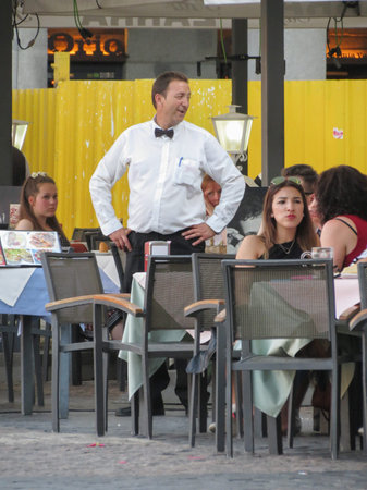 MADRID, SPAIN - CIRCA JUNE 2015: waiter and customers on main squareのeditorial素材