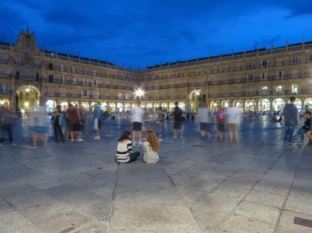 SALAMANCA, SPAIN - CIRCA JUNE 2015: blurred people on main square (Plaza Mayor) by nightの写真素材