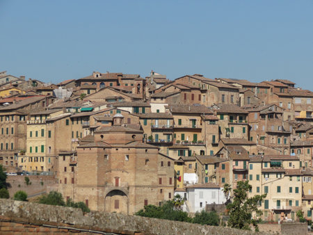 medieval city centre with red brick houses in Siena, Italyの写真素材