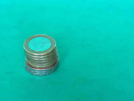 Pile of Euro coins money currency of European Union over green backgroundの写真素材