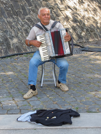 KOBLENZ, GERMANY - AUGUST 09, 2022: unidentified street musician playing the accordionのeditorial素材