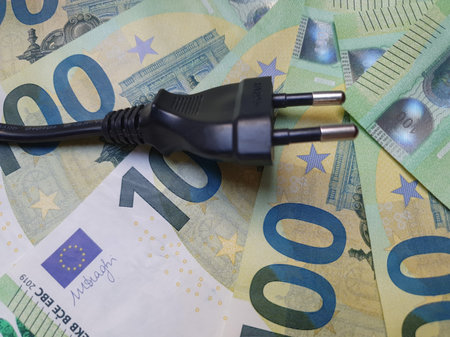 electric plug over EUR cash, expressing electricity cost conceptの写真素材