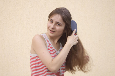 Young woman with hairbrushの写真素材