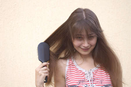 Young woman with hairbrushの写真素材