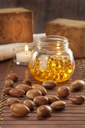 seeds of argan with yellow cosmetic pearl,light and soapの写真素材