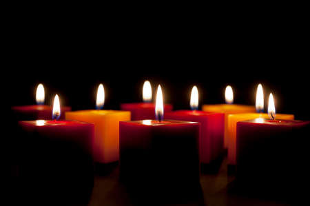 candles lighting in the darkness or in a black backgroundの写真素材