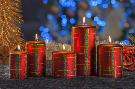 Christmas still life of home lighting candles with blue lights on backgroundの写真素材
