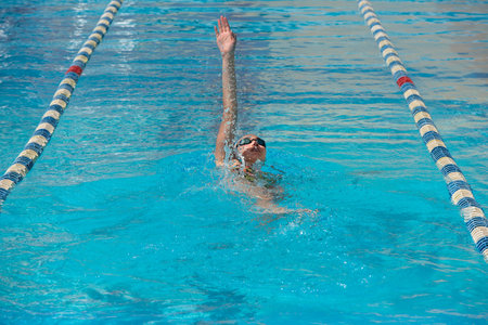 woman swimming on a blue water pool