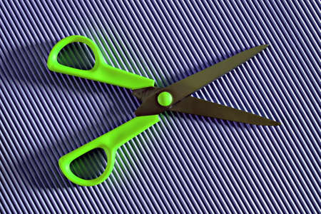 green open scissors on violet backgroundの写真素材