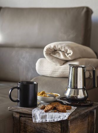 A moment of relaxation during the carentana. Coffee with brown sugar and cookies served on the sofa in the living room.の写真素材