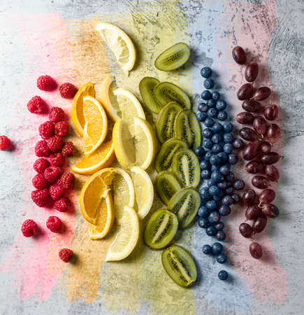 Fruits cut and arranged in order of rainbow colors. A few brushstrokes of rainbow colors. Gay Pride Day, LGBT concept.の写真素材