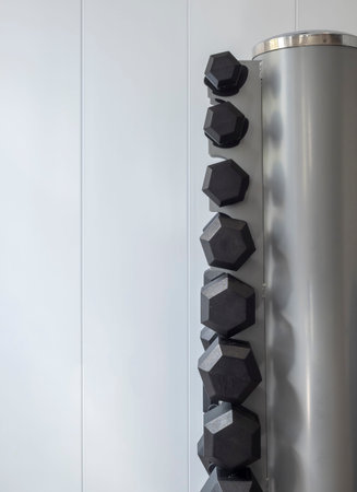 Weights arranged in a gymnasium. Material to exercise the muscles. Gym, healthy living,...
