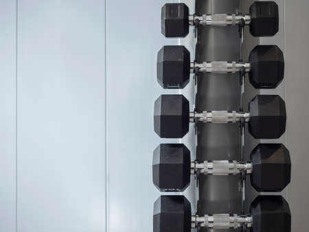 Weights arranged in a gymnasium. Material to exercise the muscles. Gym, healthy living, self-improvement.の写真素材