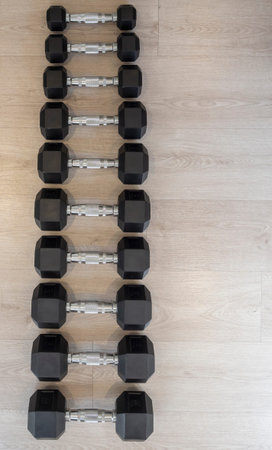 Weights arranged in a gymnasium. Material to exercise the muscles. Gym, healthy living,...