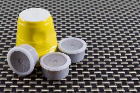 Yellow coffee cup with coffee podsの写真素材