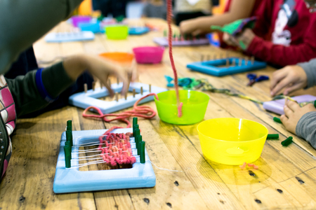 Educational weaving and knitting activity. Knitting wool for kids.の写真素材
